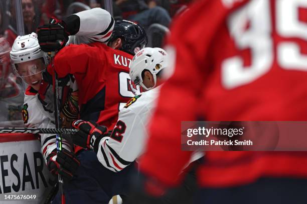 Connor Murphy of the Chicago Blackhawks is checked by Evgeny Kuznetsov of the Washington Capitals during second at Capital One Arena on March 23,...