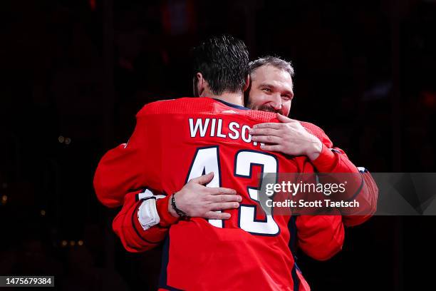 Alex Ovechkin of the Washington Capitals hugs teammate Tom Wilson while being honored during a pre-game ceremony for passing Gordie Howe for second...