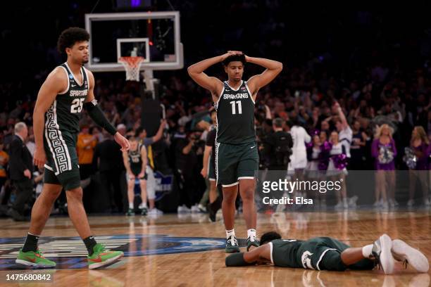 Malik Hall, A.J. Hoggard and Tyson Walker of the Michigan State Spartans react after being defeated by the Kansas State Wildcats in overtime in the...