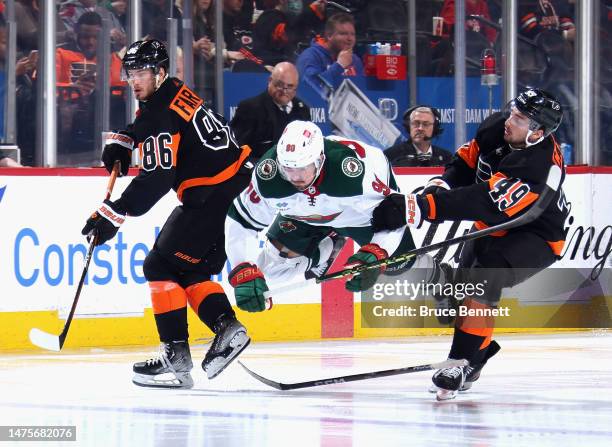 Noah Cates of the Philadelphia Flyers takes a third period penalty or tripping Marcus Johansson of the Minnesota Wild at the Wells Fargo Center on...