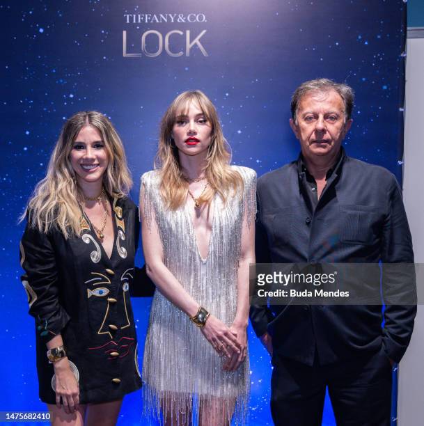 Singer Suki Waterhouse poses for pictures with Laurita Mourao VP of marketing of Tiffany and Stephane le Forestier, in front of the backdrop of the...