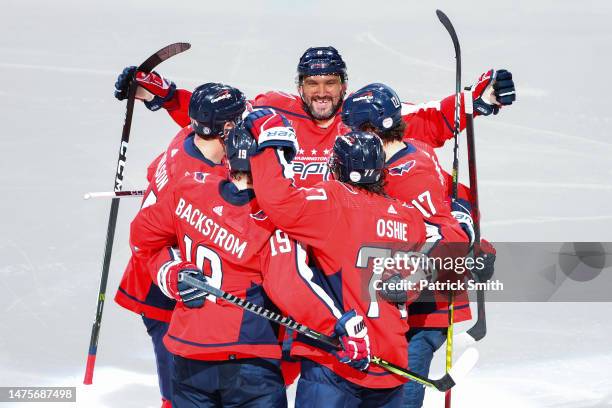 Alex Ovechkin of the Washington Capitals celebrates with teammates after John Carlson scored a goal against the Chicago Blackhawks during the third...