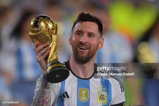 Lionel Messi of Argentina celebrates with the FIFA World Cup trophy during celebrations after an international friendly match between Argentina and...