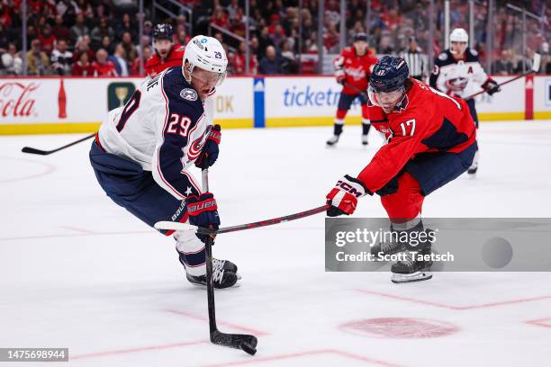 Patrik Laine of the Columbus Blue Jackets and Dylan Strome of the Washington Capitals vie for the puck during the second period of the game at...