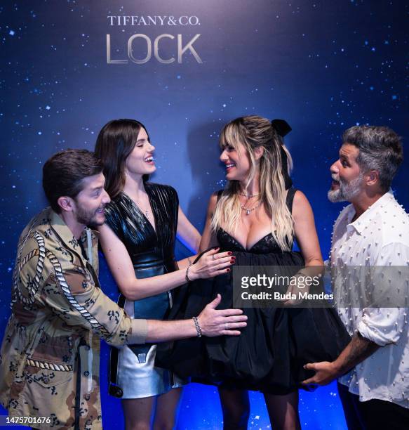 Actor Klebber Toledo, Camila Queiroz, Gio Ewbank and the actor Bruno Gagliasso pose for pictures in front of the backdrop of the Tiffany & Co. Lock...