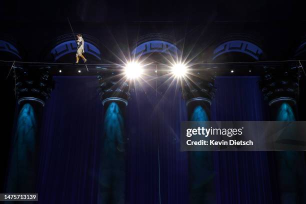 Philippe Petit, the French high wire artist, performs during his show "Wonder on the Wire," at the National Building Museum on March 23, 2023 in...