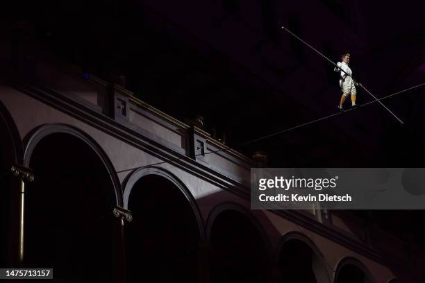 Philippe Petit, the French high wire artist, performs during his show "Wonder on the Wire," at the National Building Museum on March 23, 2023 in...