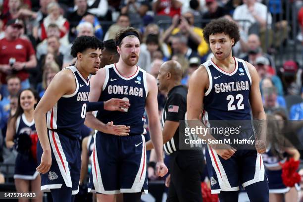Anton Watson of the Gonzaga Bulldogs reacts after drawing a foul with teammates Julian Strawther and Drew Timme during the second half against the...
