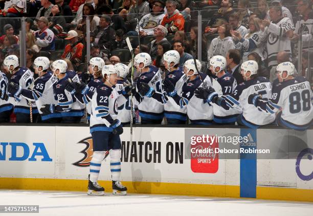 Mason Appleton of the Winnipeg Jets skates by his team bench and celebrates with teammates after scoring a goal during the first period of the game...