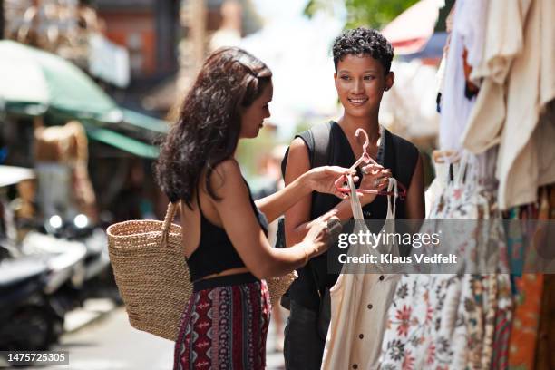 friends buying dress from street market - indonesia street stock pictures, royalty-free photos & images