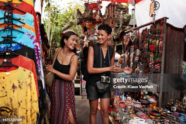 friends talking to each other during vacation - tourist market stock pictures, royalty-free photos & images