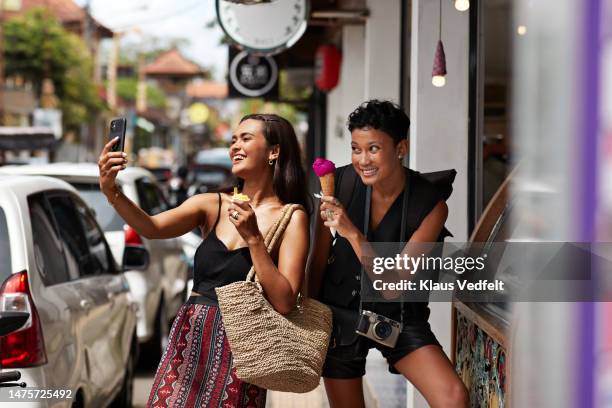 friends taking selfie while enjoying ice cream - indonesia street stock pictures, royalty-free photos & images