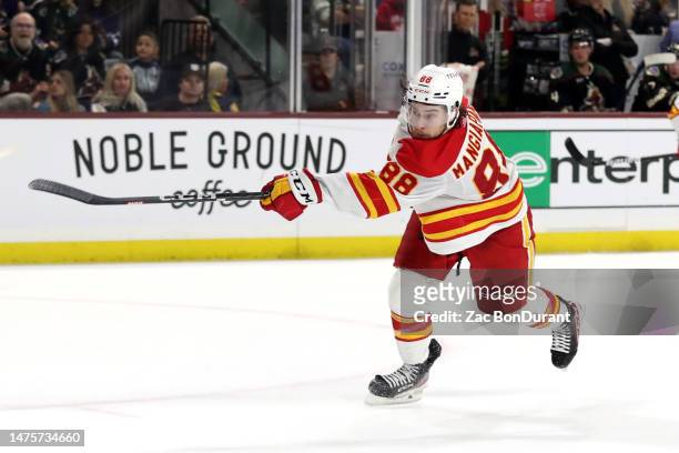 Andrew Mangiapane of the Calgary Flames takes a shot against the Arizona Coyotes at Mullett Arena on March 14, 2023 in Tempe, Arizona.
