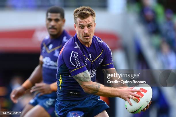 Cameron Munster of the Storm looks to pass the ball during the round four NRL match between the Melbourne Storm and Wests Tigers at AAMI Park on...