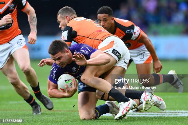 Trent Loiero of the Storm is tackled during the round four NRL match between the Melbourne Storm and Wests Tigers at AAMI Park on March 24, 2023 in...