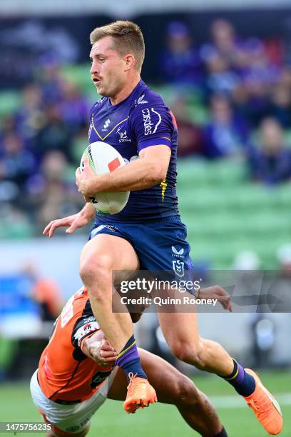 Cameron Munster of the Storm is tackled during the round four NRL match between the Melbourne Storm and Wests Tigers at AAMI Park on March 24, 2023...