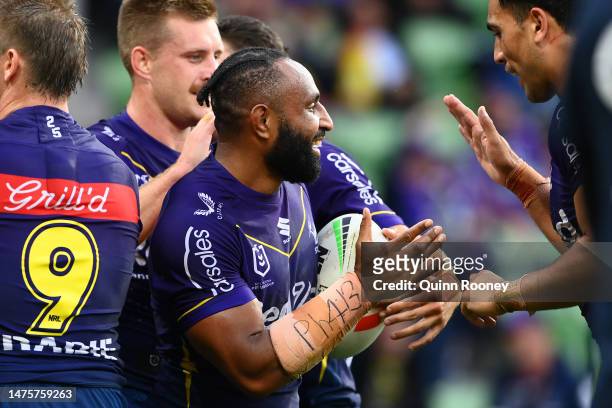 Justin Olam of the Storm celebrates with team mates after scoring a try during the round four NRL match between the Melbourne Storm and Wests Tigers...