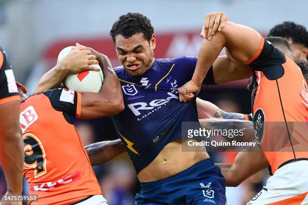 Xavier Coates of the Storm is tackled during the round four NRL match between the Melbourne Storm and Wests Tigers at AAMI Park on March 24, 2023 in...