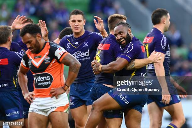 Justin Olam of the Storm celebrates with try-scorer Cameron Munster of the Storm during the round four NRL match between the Melbourne Storm and...