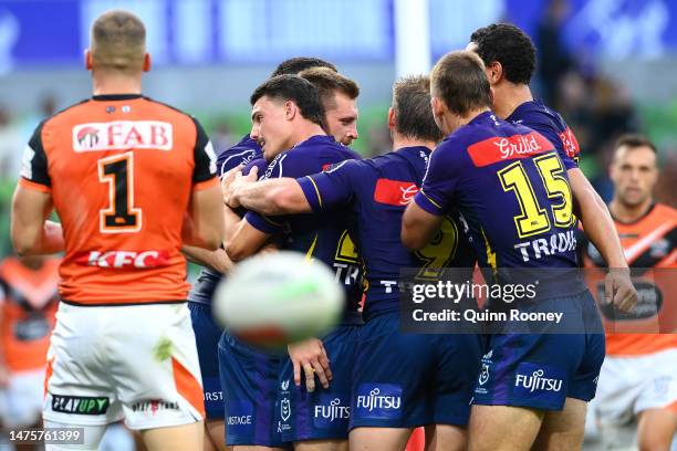 Cameron Munster of the Storm celebrates with team mates after scoring a try during the round four NRL match between the Melbourne Storm and Wests...