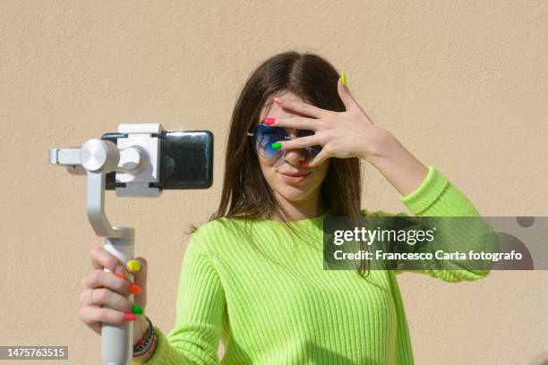 woman influencer take a selfie with smartphone - hiding face stock pictures, royalty-free photos & images