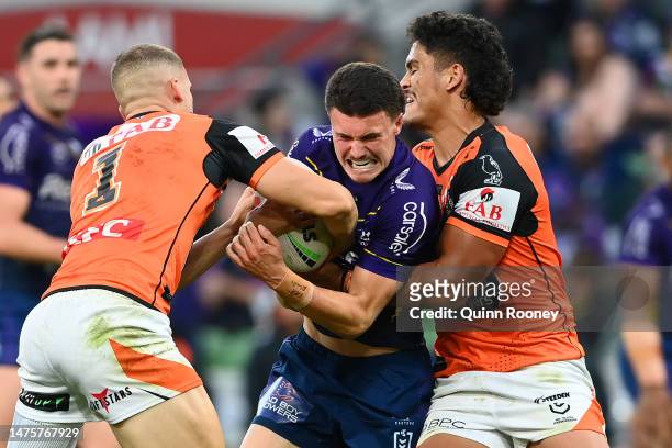 Jonah Pezet of the Storm is tackled during the round four NRL match between the Melbourne Storm and Wests Tigers at AAMI Park on March 24, 2023 in...