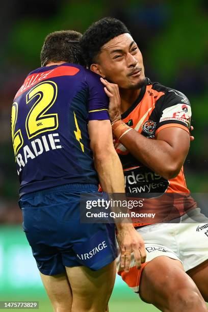 Junior Tupou of the Tigers is tackled by Jonah Pezet of the Storm during the round four NRL match between the Melbourne Storm and Wests Tigers at...