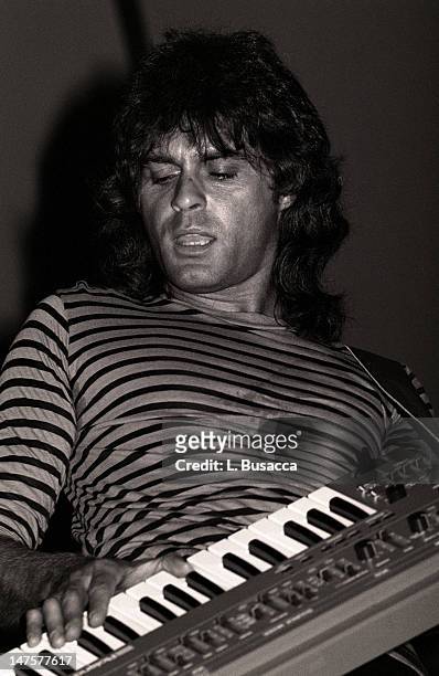 English musician Richard Wright, of the group Pink Floyd, performs in concert, New York, New York, circa 1984.