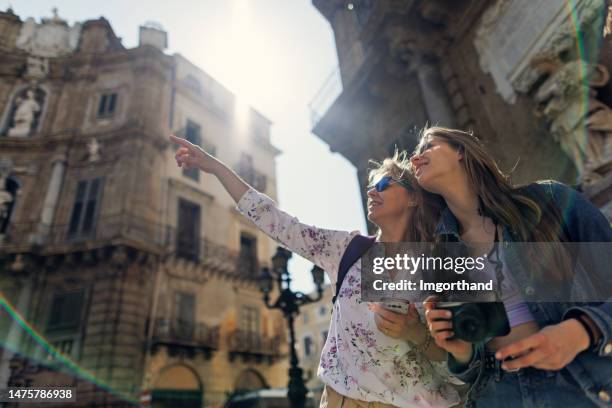 mother and teenage daughter sightseeing the famous quattro canti in palermo, sicily, italy - palermo sicily stock pictures, royalty-free photos & images