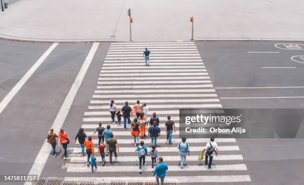 aerial view of a crowd crossing the street - follow the leader stock pictures, royalty-free photos & images