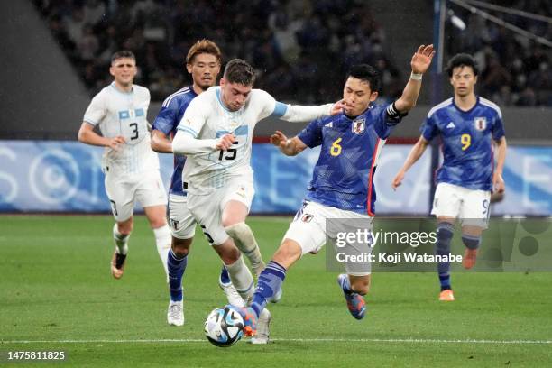Federico Valverde of Uruguay and Wataru Endo of Japan compete for the ball during the international friendly match between Japan and Uruguay at the...