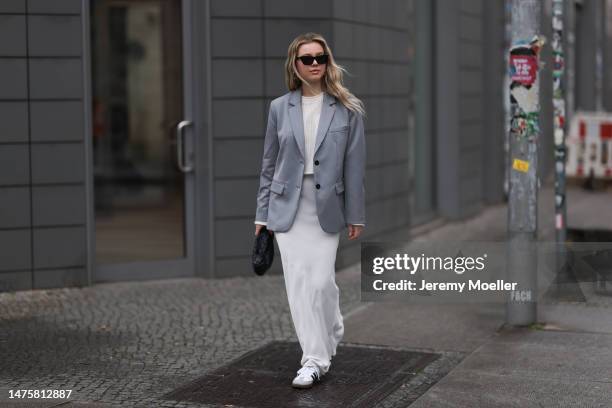 Isabelle Hartmann seen wearing YSL black sunglasses, House of Dagmar white silk long skirt, Vival Studio white cropped knit, Anine Bing grey blazer,...