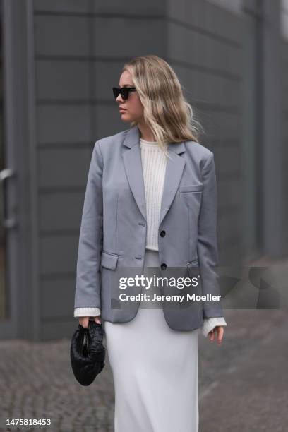 Isabelle Hartmann seen wearing YSL black sunglasses, silver earrings, House of Dagmar white silk long skirt, Vival Studio white cropped knit, Anine...