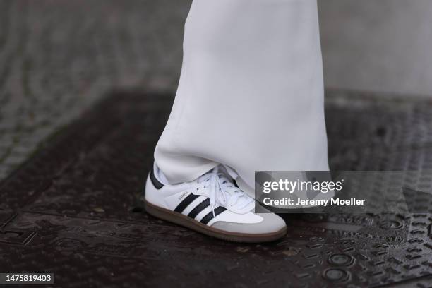 Isabelle Hartmann seen wearing House of Dagmar white silk long skirt, Adidas Samba white sneaker, on March 23, 2023 in Berlin, Germany.