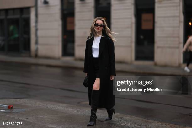 Isabelle Hartmann seen wearing Chanel black oval black sunglasses, silver earrings, By Aylin Koenig black mini skirt, Victoria Luise white cotton...