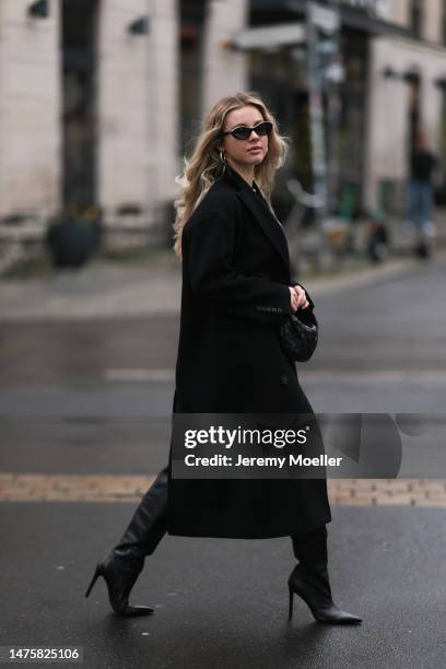 Isabelle Hartmann seen wearing Chanel black oval black sunglasses, silver earrings, By Aylin Koenig black mini skirt, Victoria Luise white cotton...