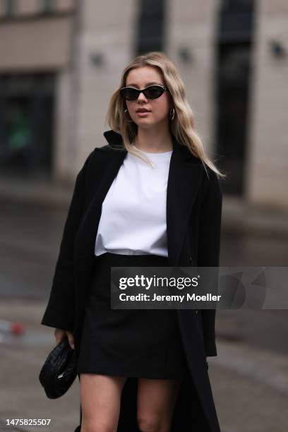 Isabelle Hartmann seen wearing Chanel black oval black sunglasses, silver earrings, By Aylin Koenig black mini skirt, Victoria Luise white cotton...