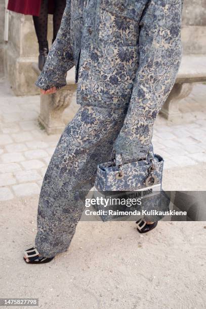 Mina Kavani seen wearing a matching set with an oversized patterned blazer and wide leg pants, a matching bag and high heels outside Dior, during...