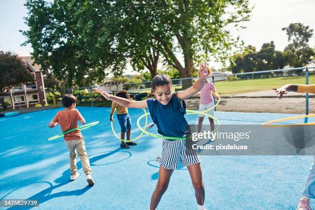 children, hula hoop and friends playing outdoor together during break or recess on a school playground. kids, games or fun with girl and boy students bonding while having fun outside during summer - lekplats bildbanksfoton och bilder