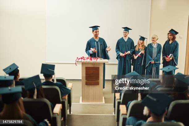 happy black awarded student giving a speech on graduation in lecture hall. - graduation speech stock pictures, royalty-free photos & images