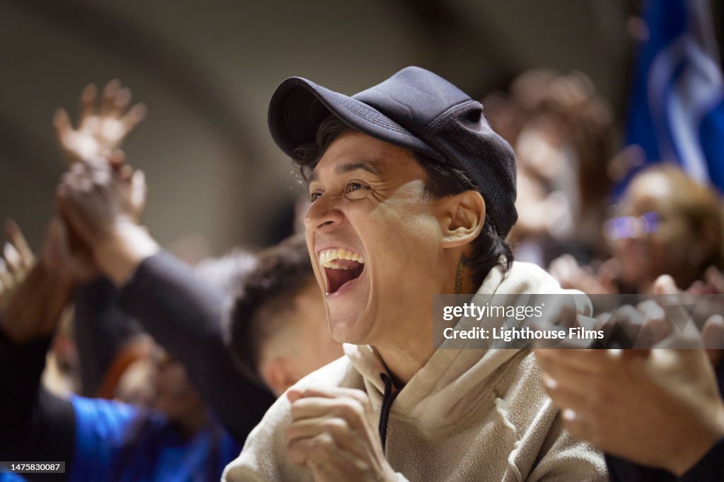 A young spectator cheers with joy at a sporting event.