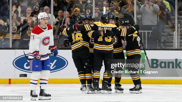 David Pastrnak of the Boston Bruins celebrates his 49th goal of the year with his teammates David Krejci, Matt Grzelcyk, Charlie McAvoy and Tyler...