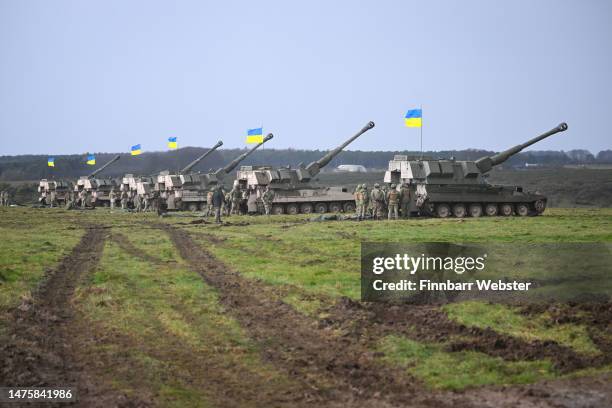 155mm self-propelled guns with Ukrainian flags are seen during final training, on March 24, 2023 in South West, England. Ukrainian artillery recruits...