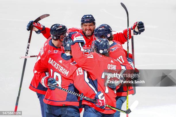 Alex Ovechkin of the Washington Capitals celebrates with teammates, Nicklas Backstrom, T.J. Oshie, and Dylan Strome, after John Carlson scored a goal...