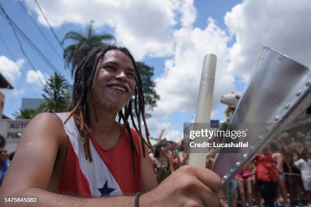 young man playing “cowbell" musical instrument. - cowbell stock pictures, royalty-free photos & images