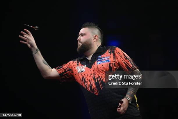 Michael Smith in throwing action during the quarter finals of the 2023 Cazoo Premier League Night Eight at Utilita Arena on March 23, 2023 in...