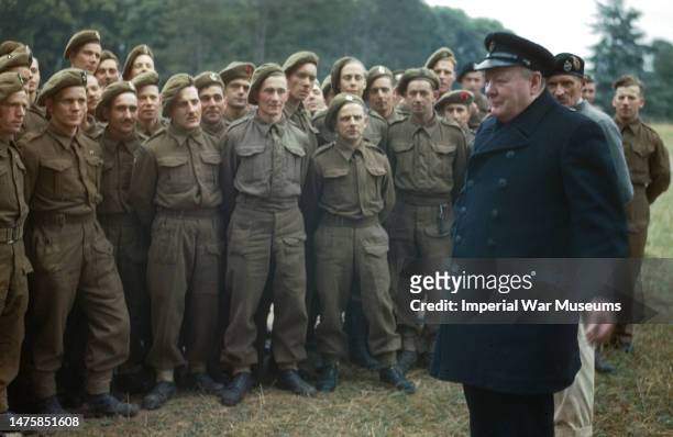 Prime Minister Winston Churchill and General Sir Bernard Montgomery, standing behind, with soldiers of the 50th Division who took part in the D-Day...