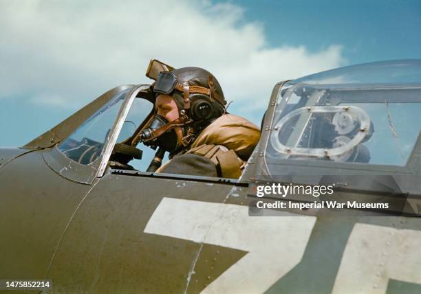 Flight Lieutenant Laurie of No. 222 Squadron, in the cockpit of Supermarine Spitfire Mark V, BM202 'ZD-H' "Flying Scotsman", RAF North Weald, Essex,...