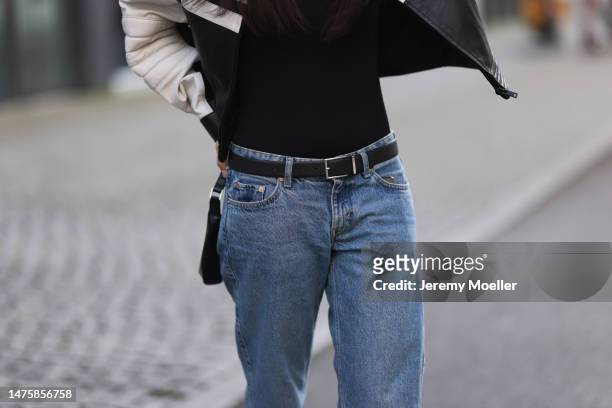 Anna Winter seen wearing Prada black top with long sleeves, Weekday blue denim jeans, silver / black leather belt, LeGer black / white biker leather...