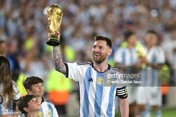 Lionel Messi of Argentina lifts the FIFA World Cup trophy during the World Champions' celebrations after an international friendly match between...